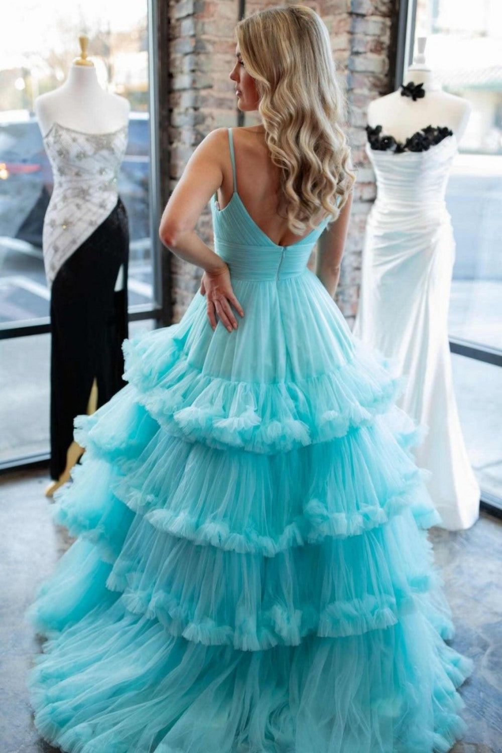 A-line V-neck tulle ball gown with double straps and multi-layered ruffles. Customizable in multiple colors.